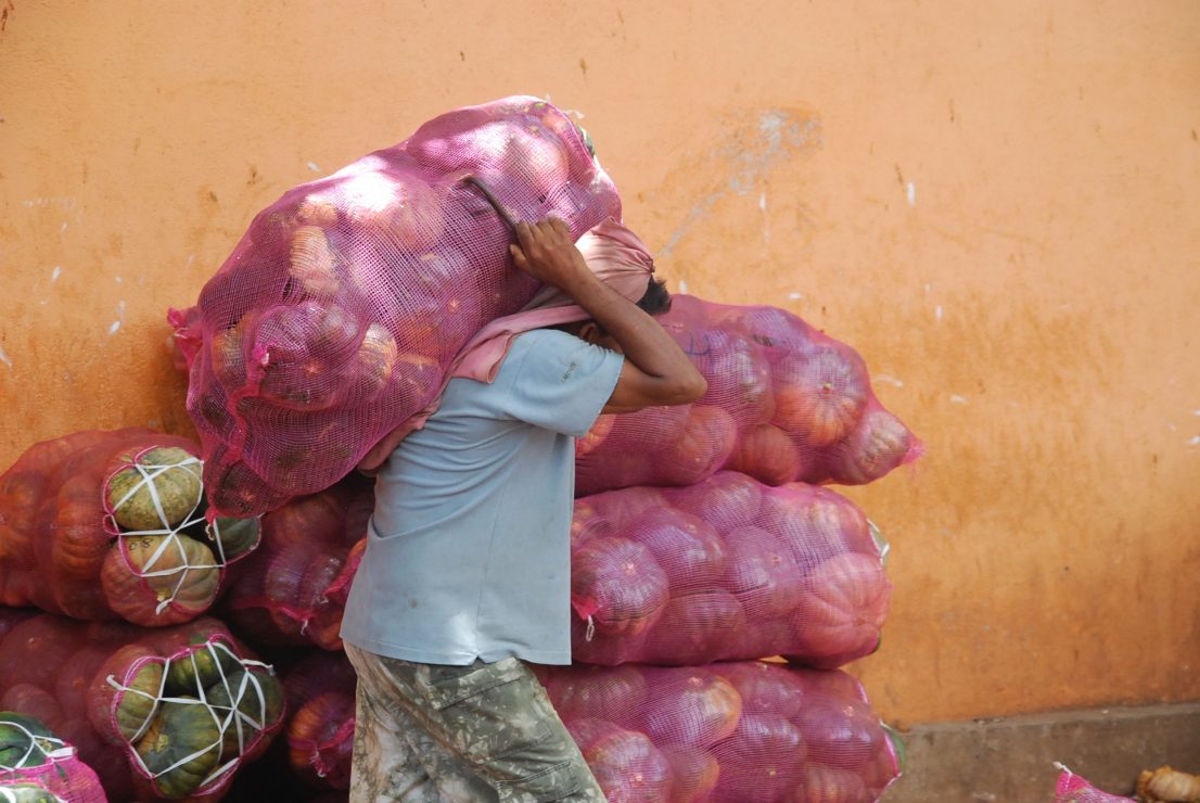 man carrying sack of melons man carrying sack of melons