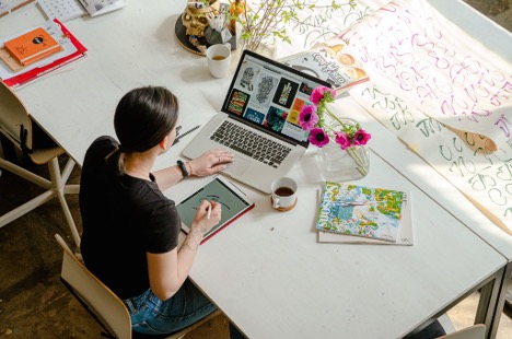 desktop, laptop, books, coffee cup