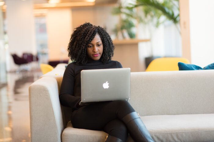 women with laptop on couch